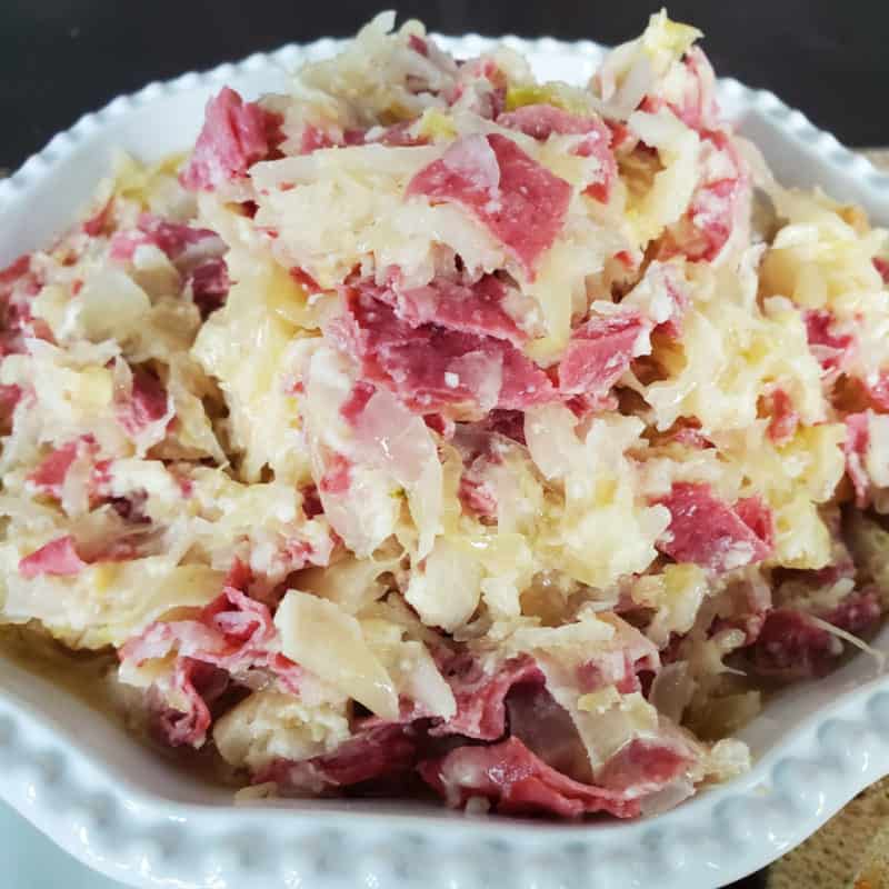 reuben dip with corned beef in a white bowl