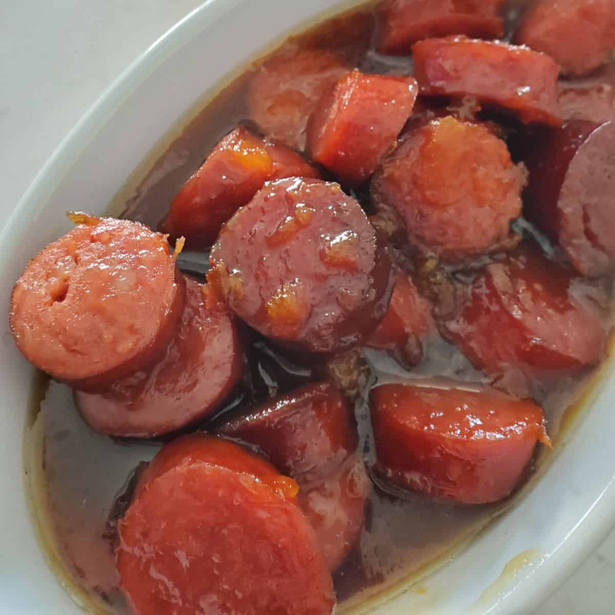 bourbon glazed kielbasa in a white bowl