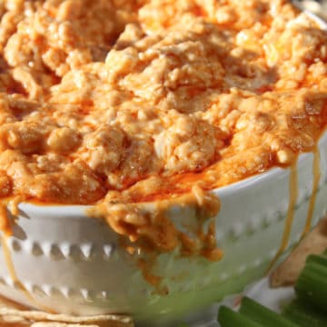 Crockpot Buffalo Chicken Dip in a white bowl with celery