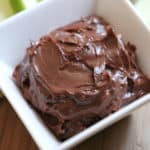 Edible Brownie Batter in a white bowl next to apple slices