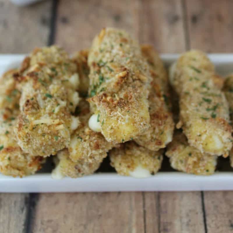 Homemade Baked Mozzarella Sticks on a white platter