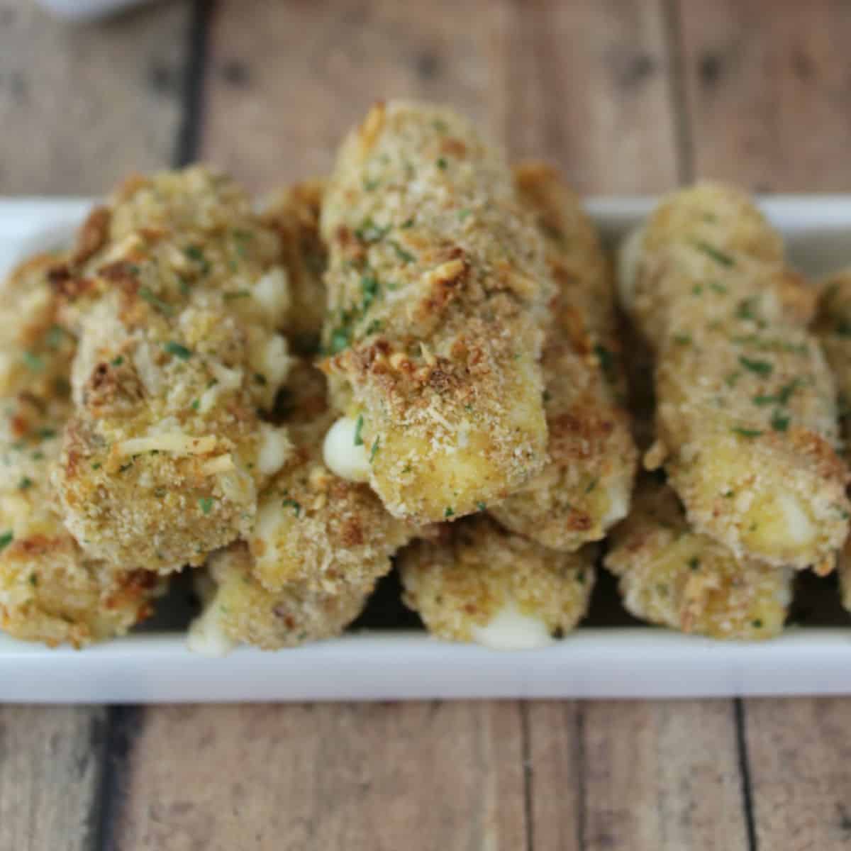 Homemade Baked Mozzarella Sticks on a white platter