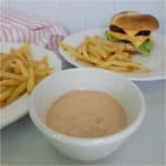 White bowl filled with In n Out Sauce next to a burger and fries