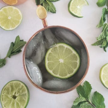 Irish Mule in a copper mug with lime wheels and mint