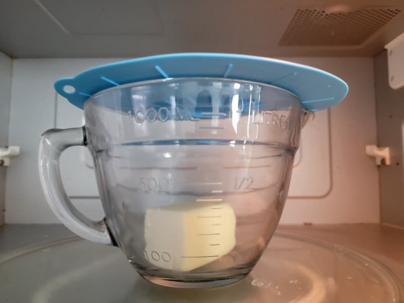 microwave splatter cover for butter over a glass bowl