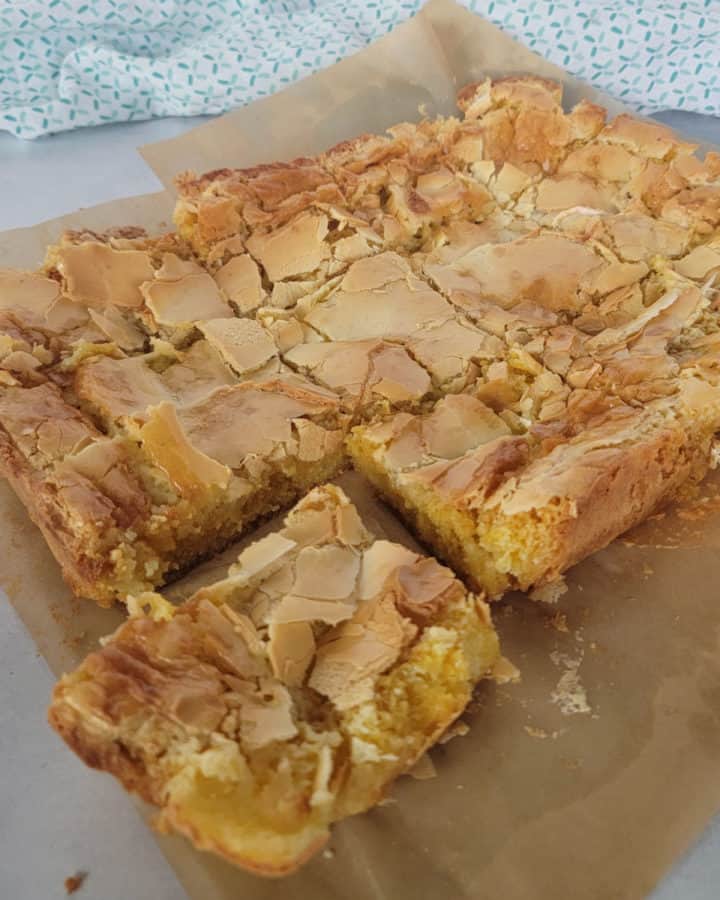Ooey Gooey Butter Cake recipe on parchment paper with a cloth napkin