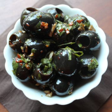 marinated olives in a white bowl