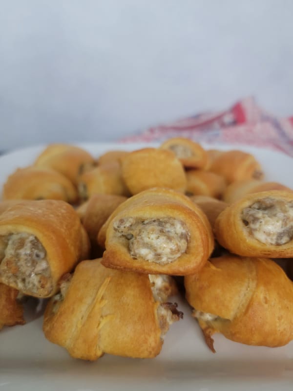 Sausage cream cheese crescent rolls on a white platter