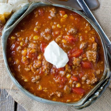 Crock Pot Camp Stew in a dark bowl on a cloth napkin