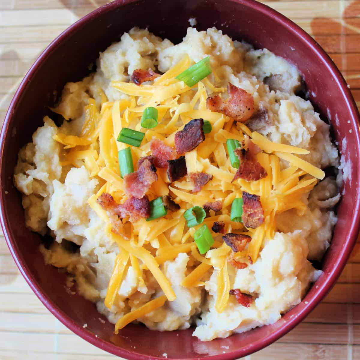 Crockpot Cheesy Potato Soup in a dark red bowl