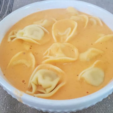 Slow Cooker Tomato Tortellini Soup in a white bowl