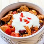 Southwest Crockpot Chicken Chili with sour cream garnish in a cream colored bowl