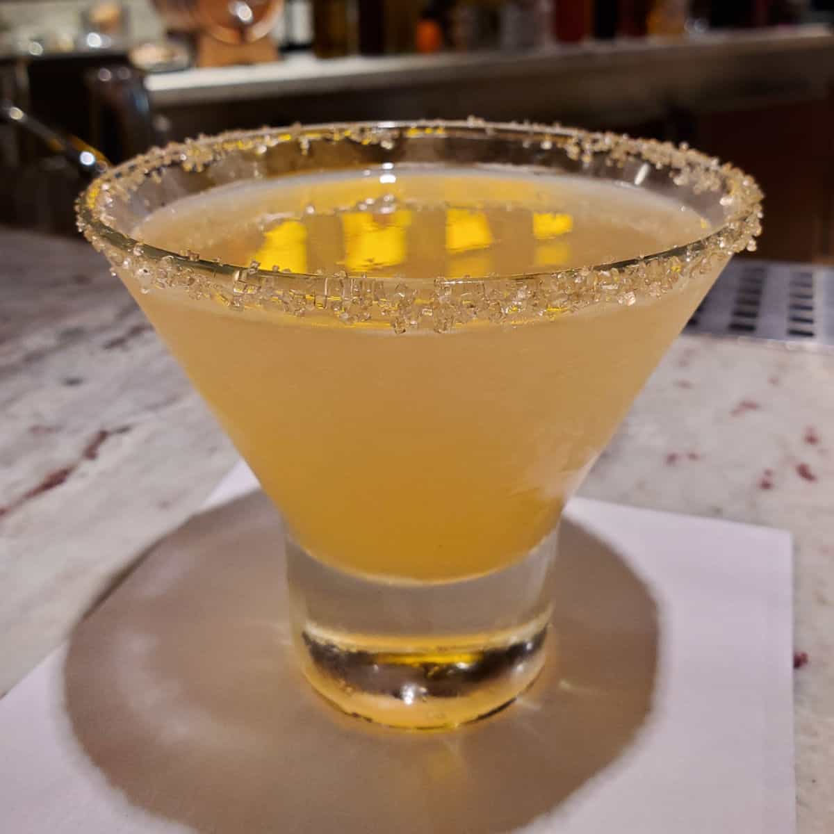 Alchemist Sidecar in a stemless martini glass with sugared rim