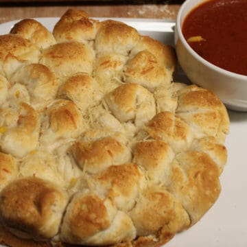 Cheesy Biscuit Bites next to a bowl of marinara sauce