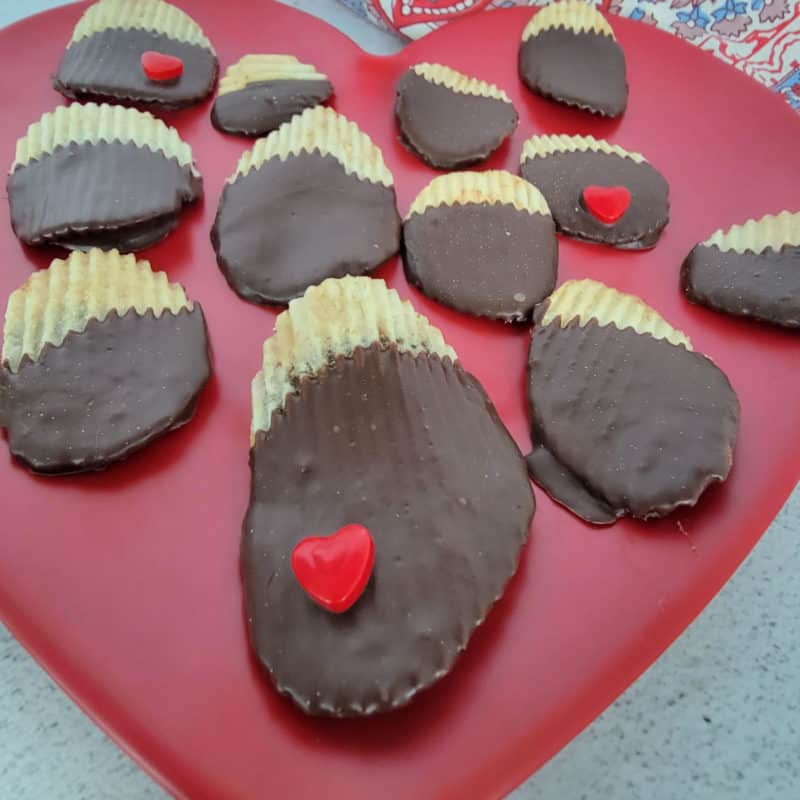 chocolate covered potato chips on a red plate