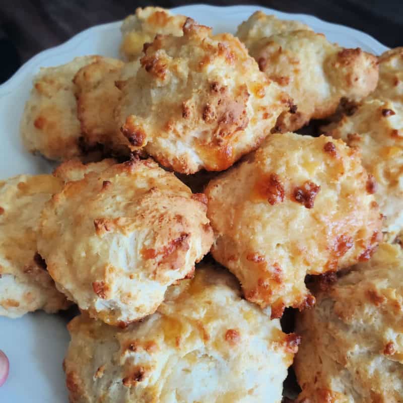 Cheddar Bay Biscuits stacked on a white plate