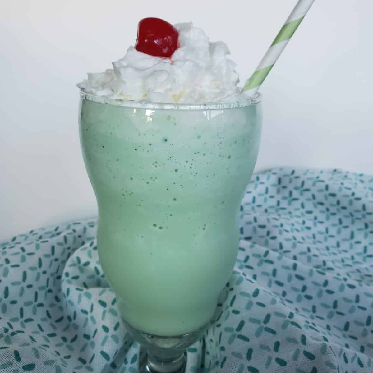 Shamrock Shake with whipped cream and a maraschino cherry