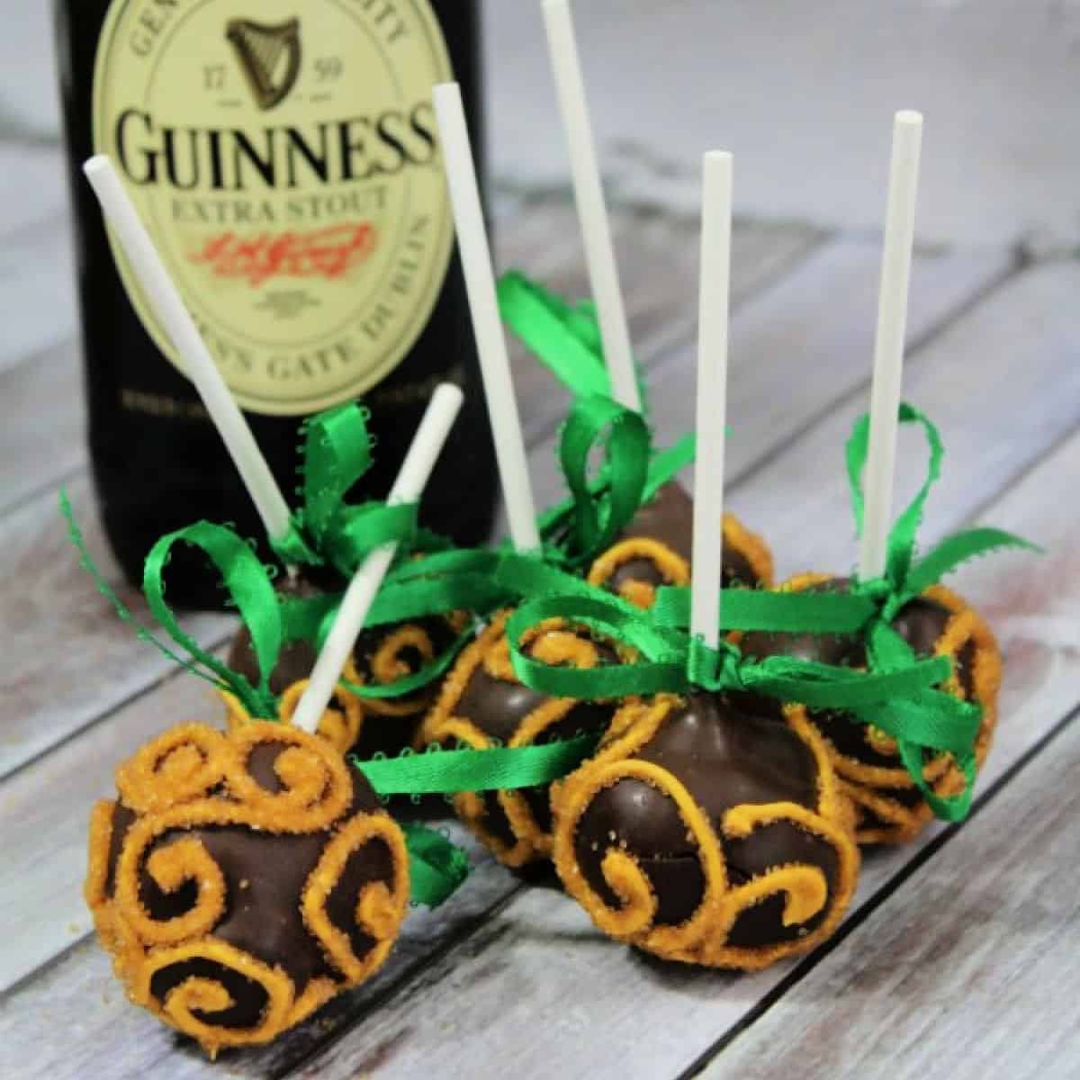 Guinness Cake Pops by a bottle of Guinness