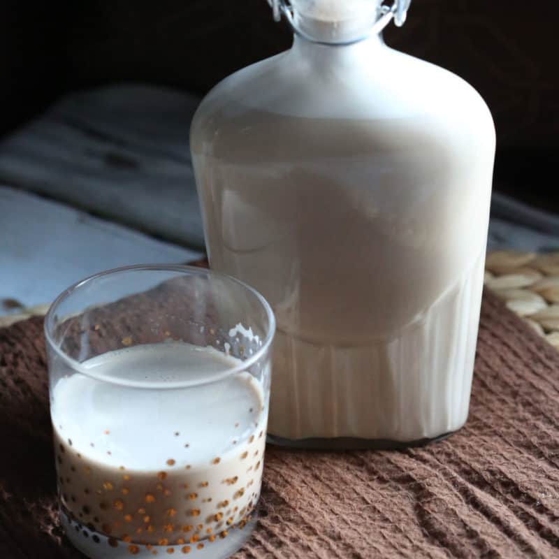 Homemade Irish Cream in a glass next to a full bottle