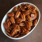 Honey glazed pecans in a white bowl