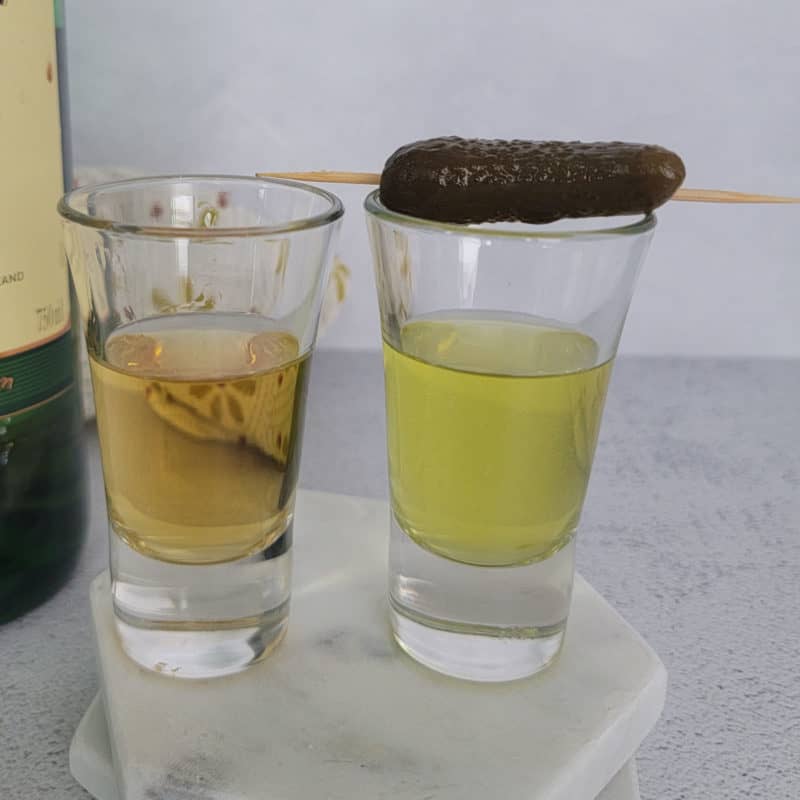 Pickleback shot in two shot glasses with a pickle garnish