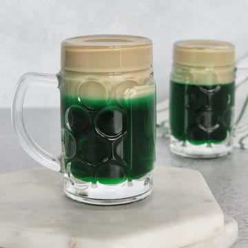 Leprechaun Beer layered shot in a mini beer glass on a white coaster