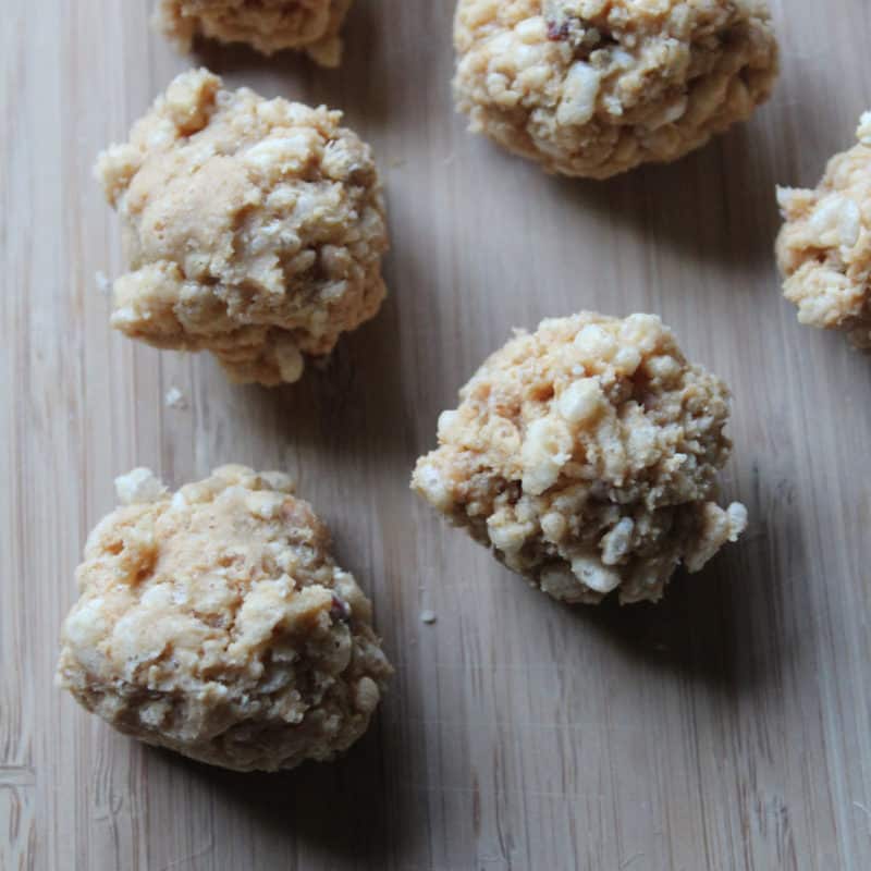No bake peanut butter balls lined up on a wood board