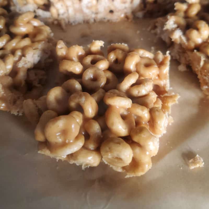 peanut butter cheerios square on parchment paper