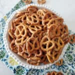 Ranch pretzels piled in a white bowl on a cloth napkin