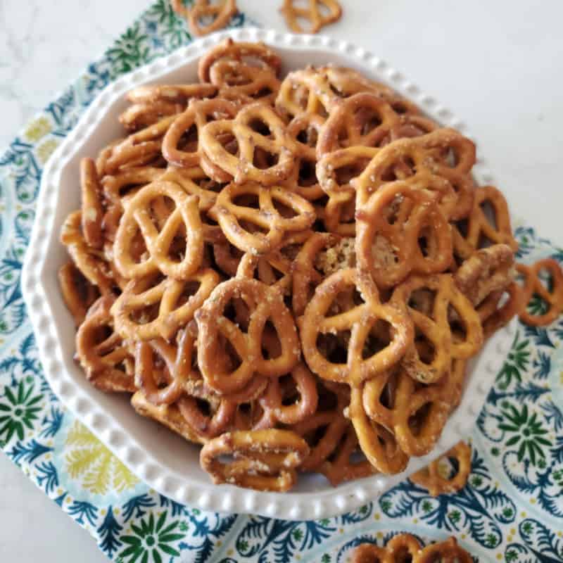 Ranch pretzels piled in a white bowl on a cloth napkin