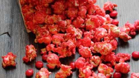 Red Hot Popcorn pouring out of a popcorn container