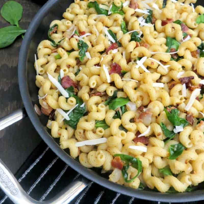 Spinach bacon pasta in a skillet