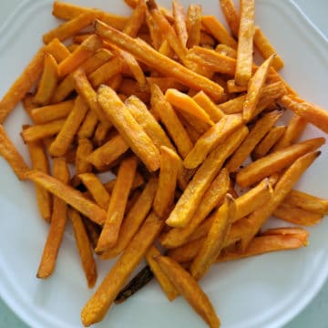 Air fried sweet potato fries on a white plate