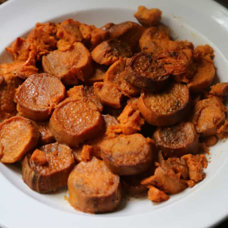 sliced candied sweet potato in a white bowl