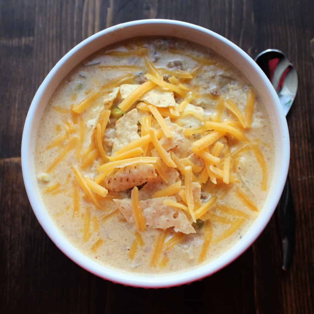 Crock Pot Cheeseburger Soup in a white bowl with a silver spoon