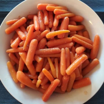 glazed carrots in a white bowl