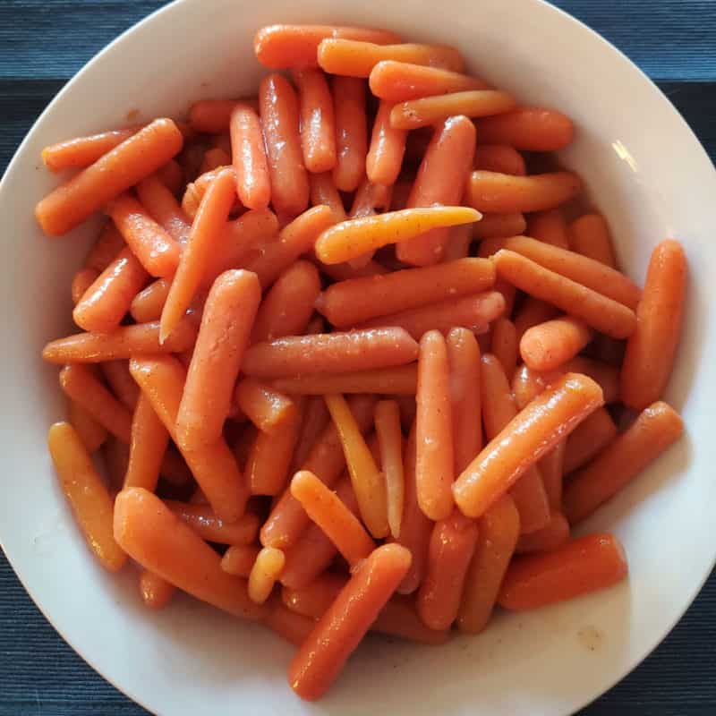 glazed carrots in a white bowl