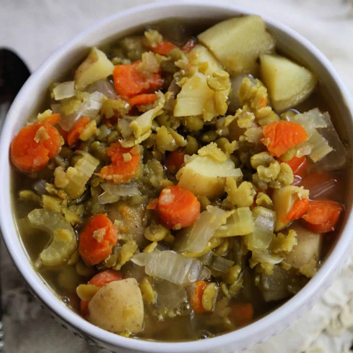 Split Pea Soup with carrots in a white bowl