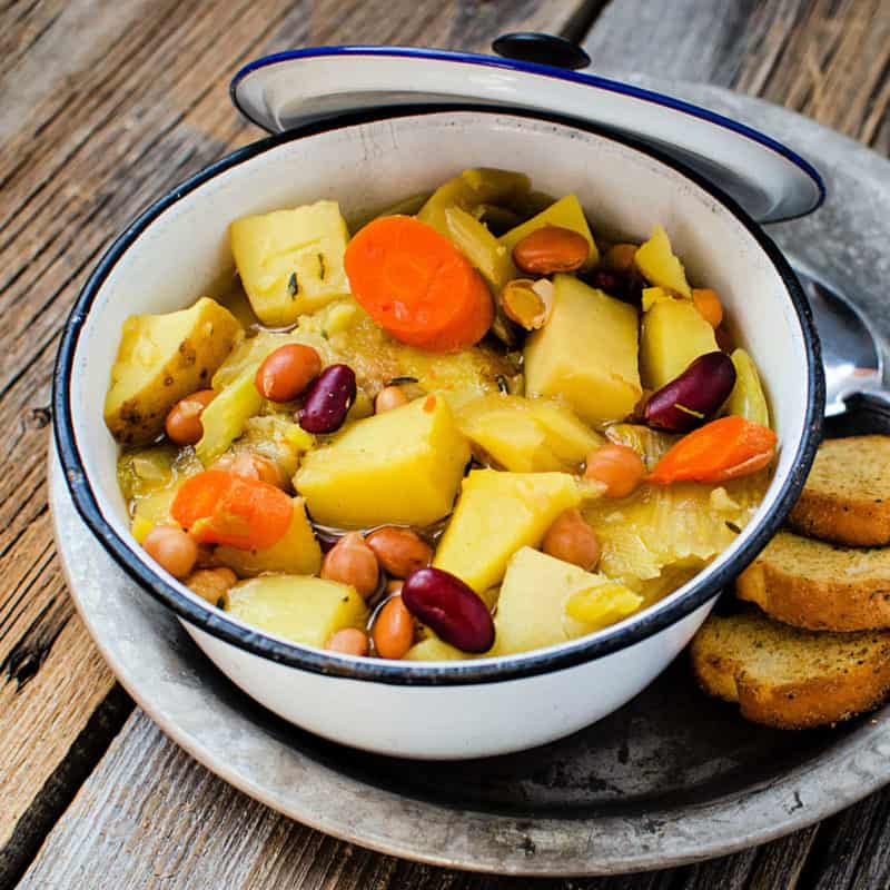 Crockpot vegetarian soup with carrots, beans, potatoes, in a pot