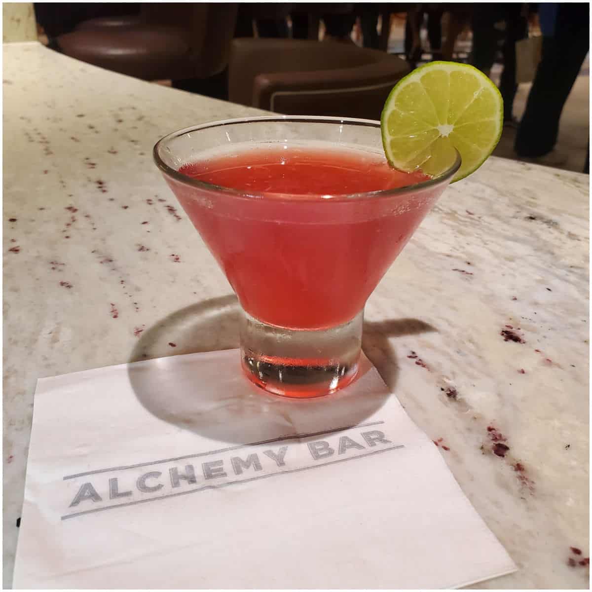 Pink 40 is the new 20 Cocktail with a lime wheel on an Alchemy Bar napkin
