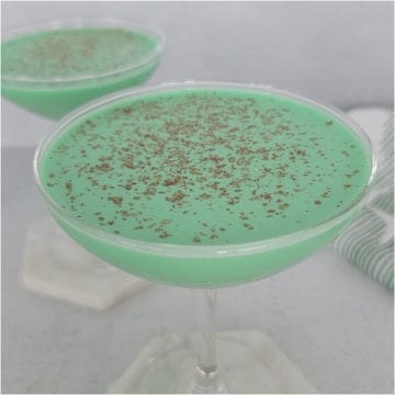 Green Grasshopper Cocktail with chocolate shavings as a garnish in a coupe glass