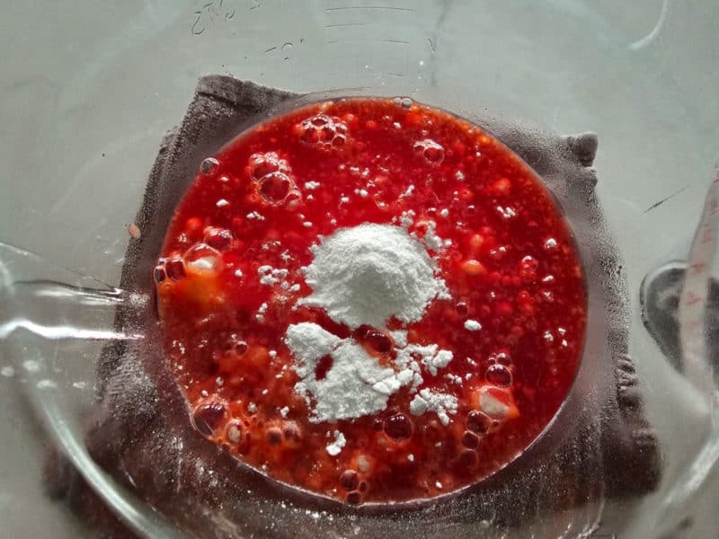 strawberry jello with vanilla pudding mix on top in a glass bowl