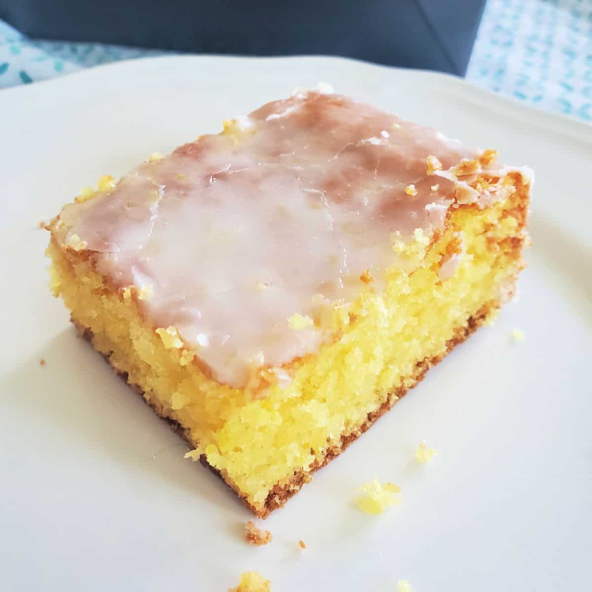 Square of Lemon Jello Cake on a white plate