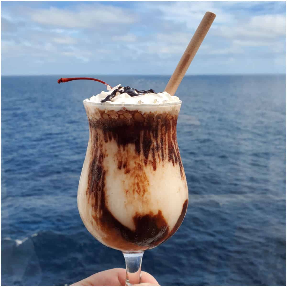 Mocha Chocolate Getaway cocktail being held with a view of the ocean