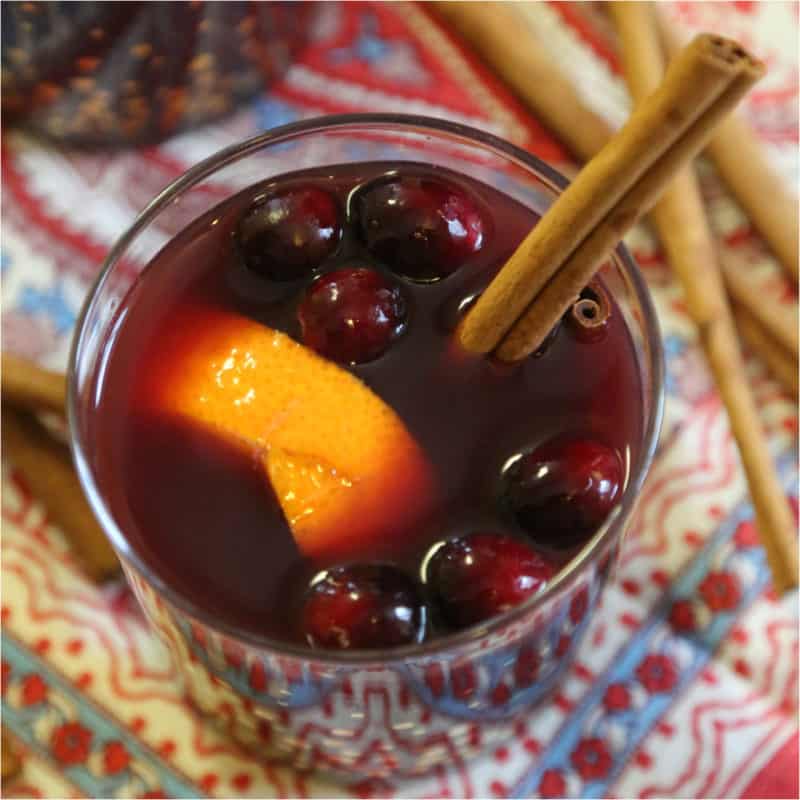 mulled white with an orange slice, cranberries, and cinnamon stick