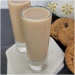 Oatmeal Cookie Shots next to oatmeal cookies and a flower napkin