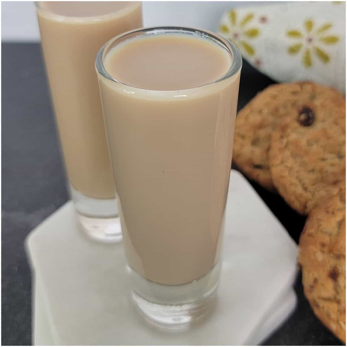 Oatmeal Cookie Shots next to oatmeal cookies and a flower napkin