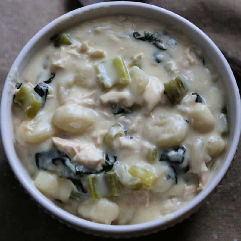Olive Garden Chicken Gnocchi Soup with chicken and celery in a white bowl