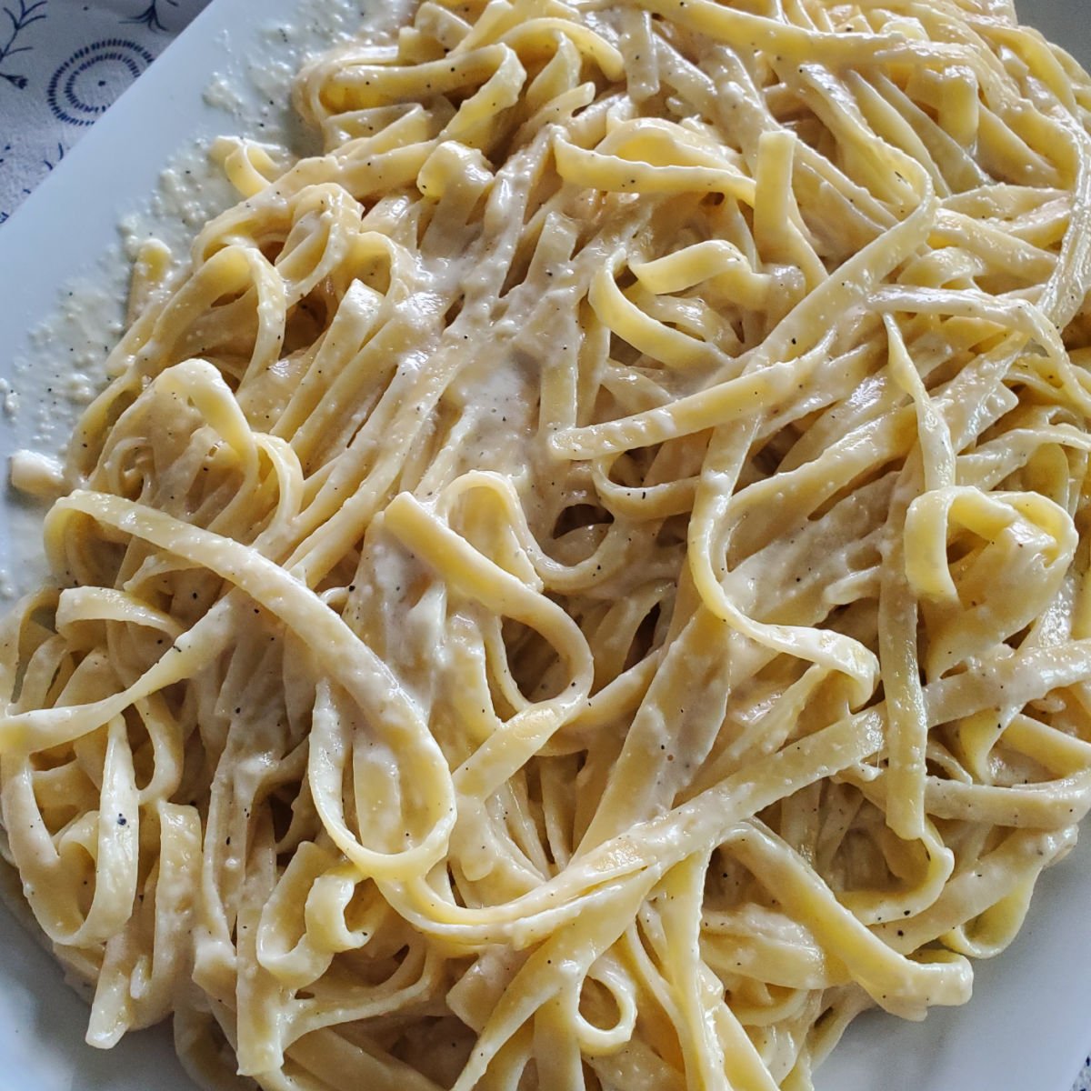 Olive Garden Fettuccini Alfredo Sauce on a white platter