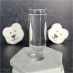 polar bear marshmallows behind a shot glass with clear liquid polar bear shot